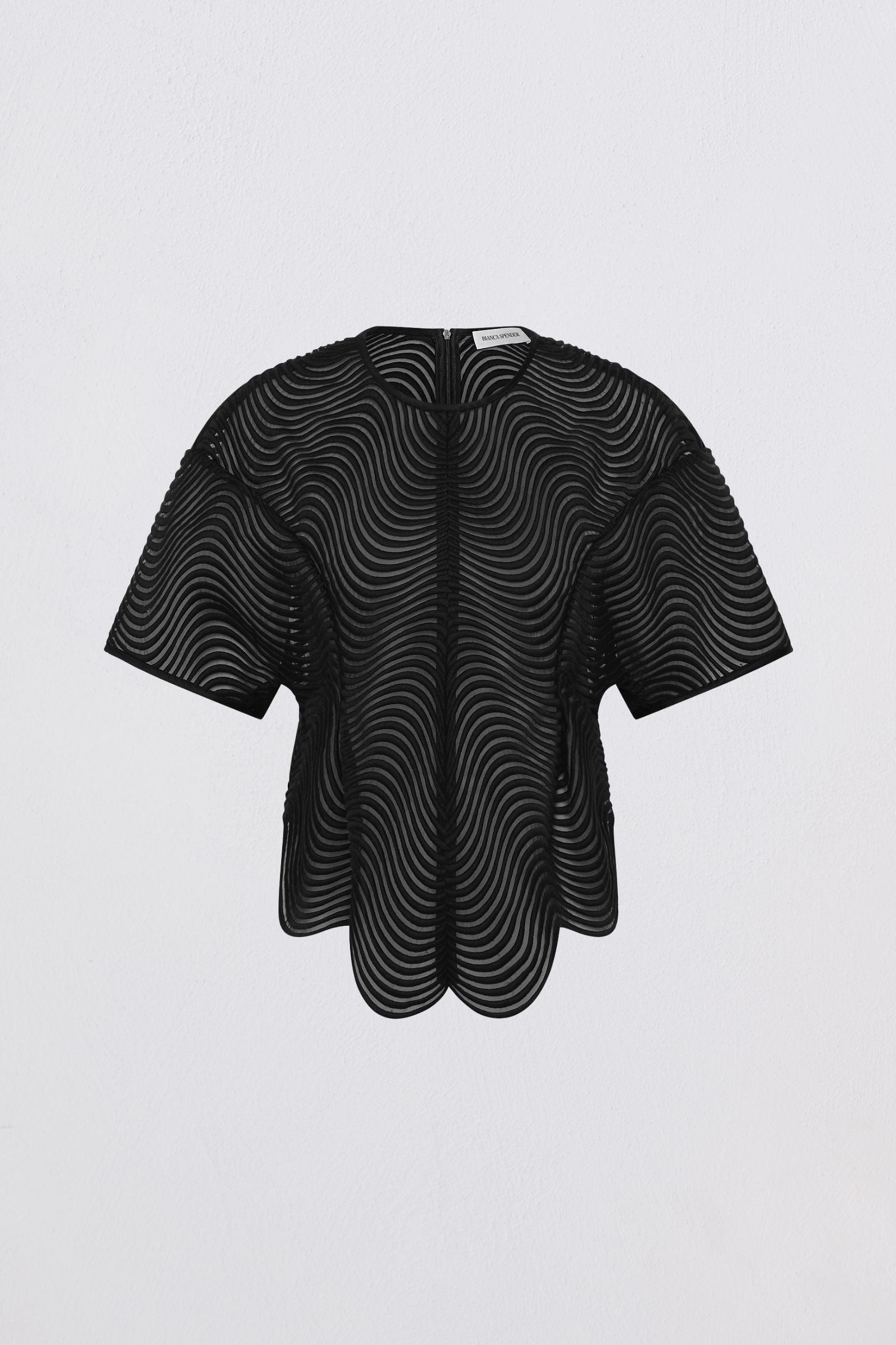 Black and white patterned top on a light gray background