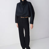 Person wearing a black outfit on a white background