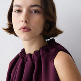 Plum satin Emerge top by Bianca Spender with gathered neckline and draped silhouette.