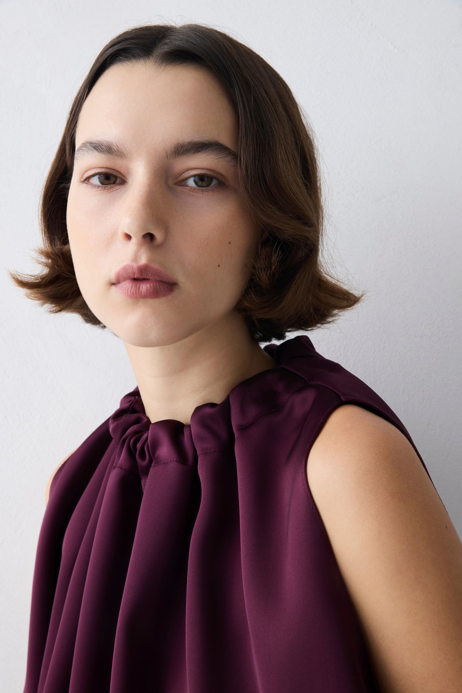 Plum satin Emerge top by Bianca Spender with gathered neckline and draped silhouette.