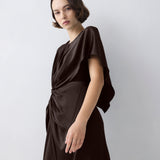 Woman wearing a black dress against a white background