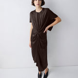 Woman wearing a brown dress against a white background