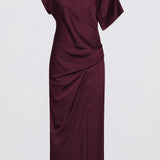 A dark burgundy one-shoulder midi dress with draped fabric details, shown against a plain light gray background.