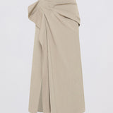 A light beige wrap-style midi skirt with a draped, gathered waist and front slit, shown against a plain white background.