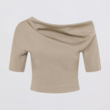 A beige off-the-shoulder short-sleeve knit top with a draped neckline, shown against a plain light gray background.