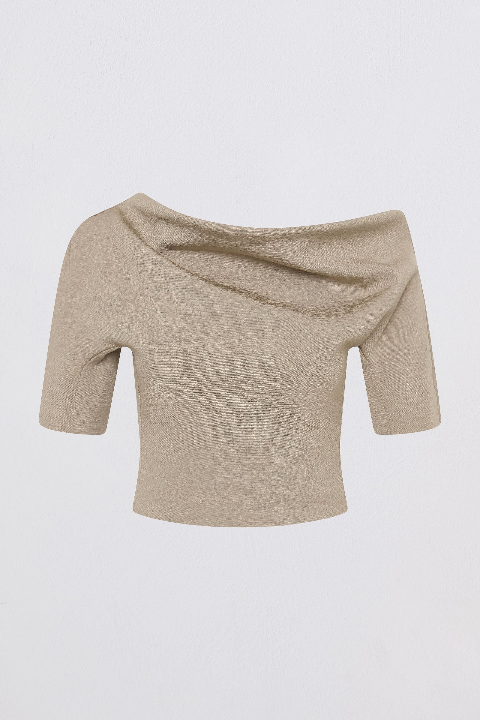 A beige off-the-shoulder short-sleeve knit top with a draped neckline, shown against a plain light gray background.