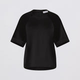 Black blouse on a light gray background