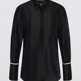 A black long-sleeve button-up shirt with a subtle vertical textured stripe pattern and contrasting white piping details on the cuffs, shown against a light gray background.