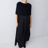 Woman wearing a black dress against a white background
