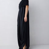 Woman wearing a black dress against a white background