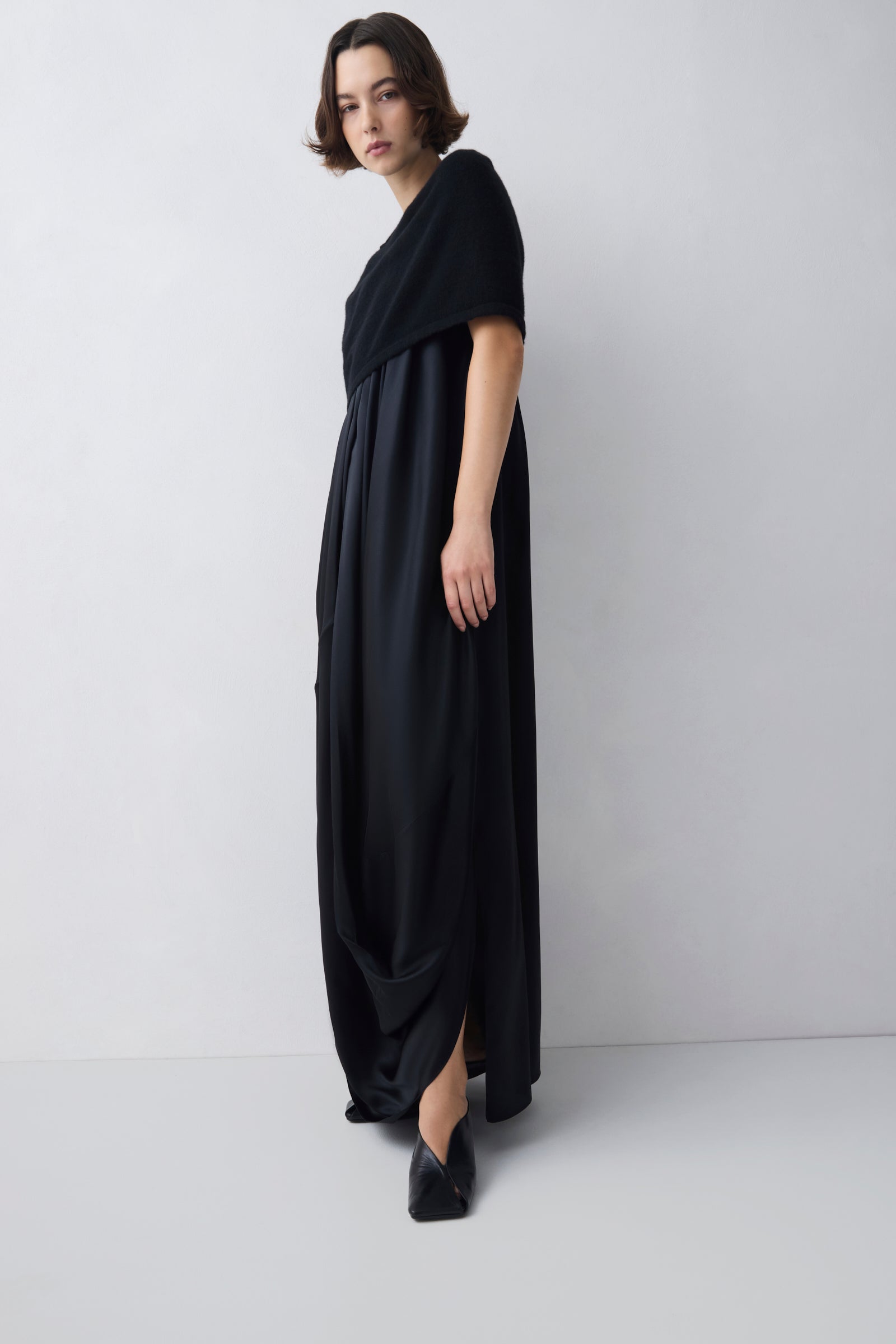 Woman wearing a black dress against a white background