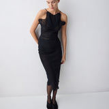 Woman wearing a black dress against a white background