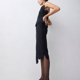 Woman wearing a black dress with sheer panels on a white background