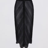 Black skirt with wavy pattern on a light gray background