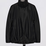 A black lightweight jacket with a high mock neck collar and drawstring hem, displayed on a clean white background.