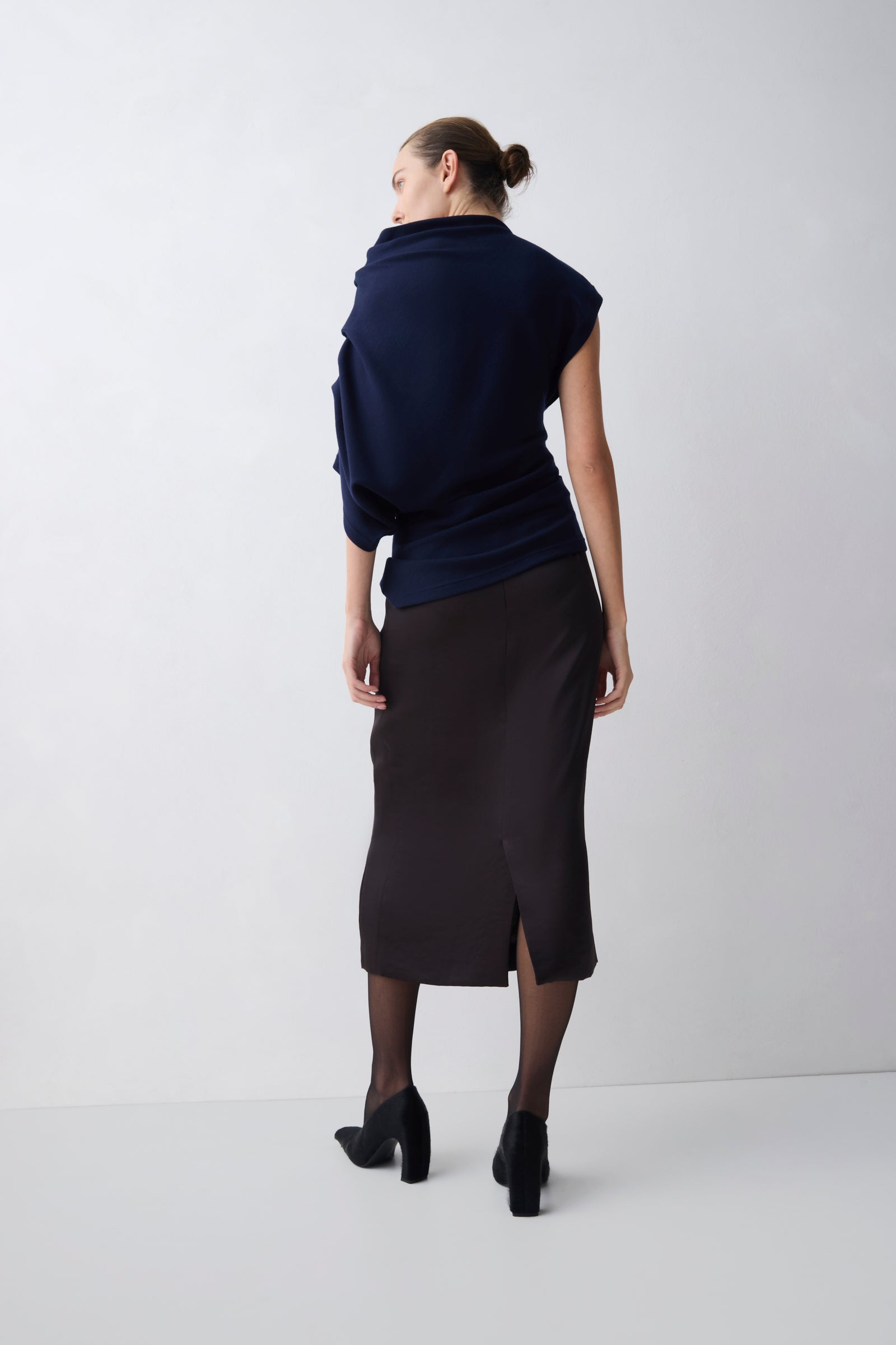 Woman wearing a dark blue outfit on a white background