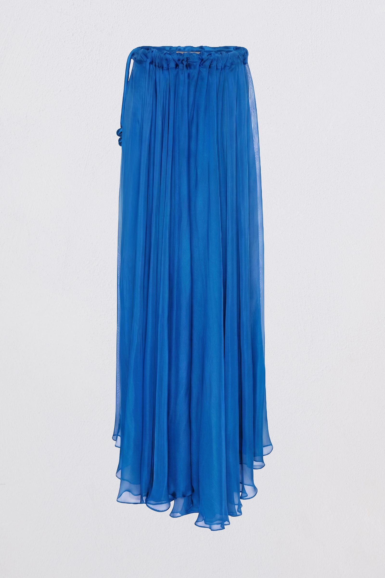 A vibrant blue pleated midi skirt made of lightweight sheer fabric, featuring an elastic waistband with side ties, shown against a plain light gray background.