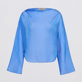 A light blue long-sleeve blouse with a wide boat neckline, displayed against a plain light gray background.