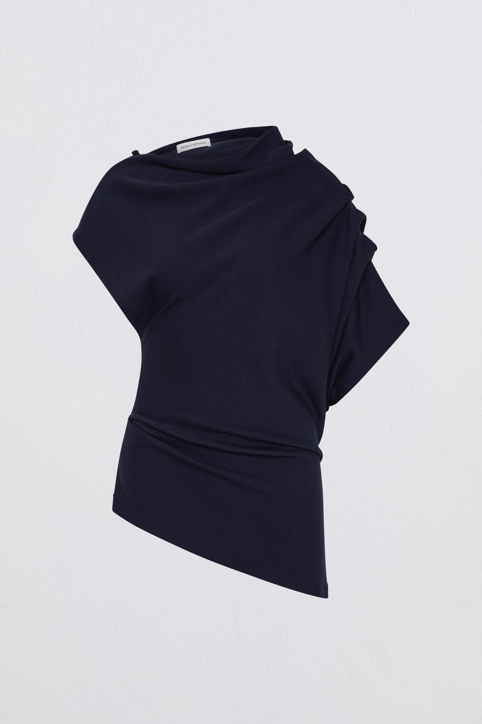 Black draped top on a light gray background