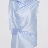 A light blue draped top with an asymmetrical layered hem, displayed on a clean white background.