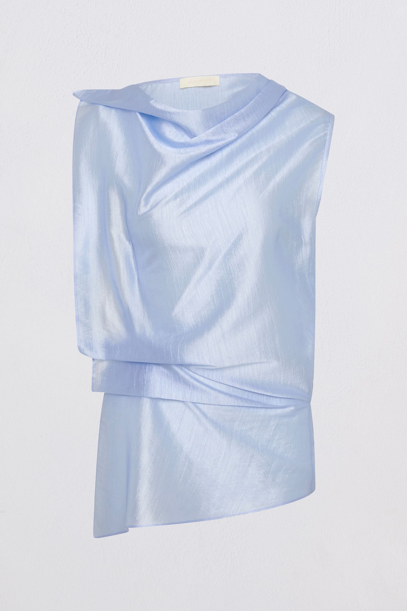 A light blue draped top with an asymmetrical layered hem, displayed on a clean white background.
