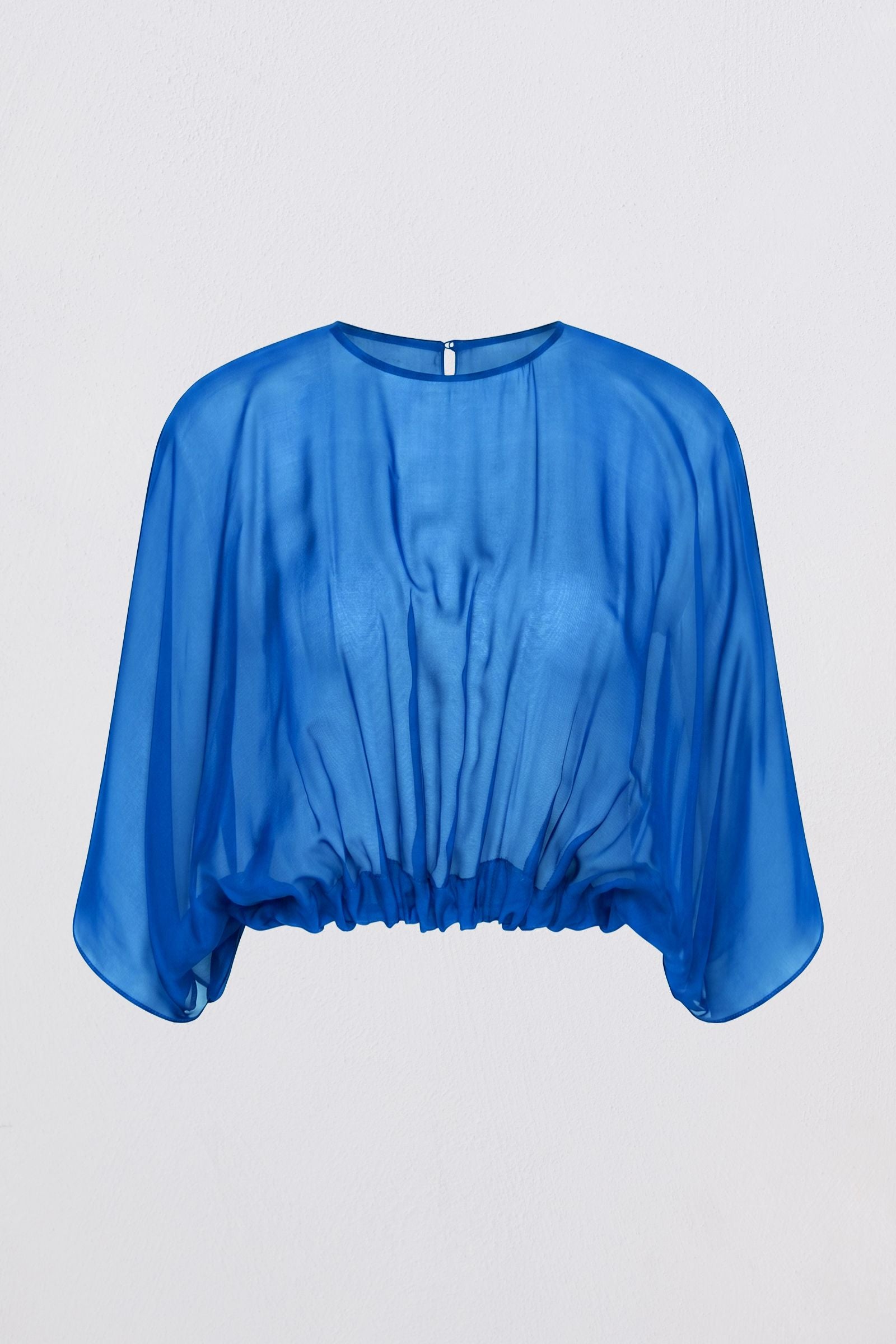 A bright blue sheer chiffon top with a round neckline and draped, elbow-length sleeves, shown against a light gray background.