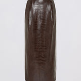 A dark brown faux-crocodile textured pencil skirt, shown flat against a light gray background.