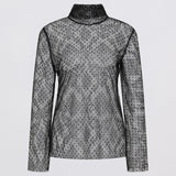Sheer black floral blouse on a white background