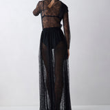 Person wearing a black lace outfit on a white background