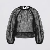 Black lace blouse on a light gray background