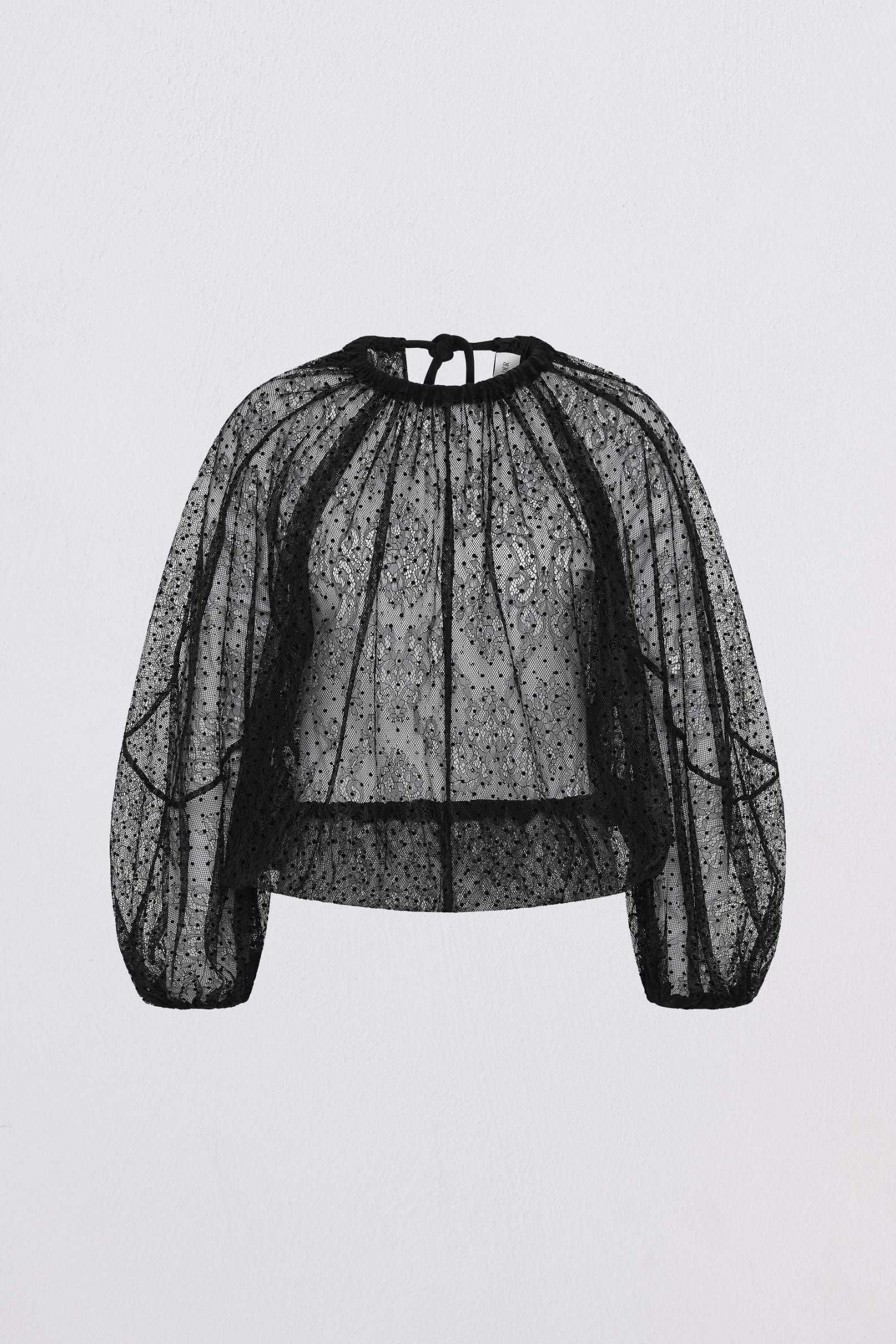 Black lace blouse on a light gray background