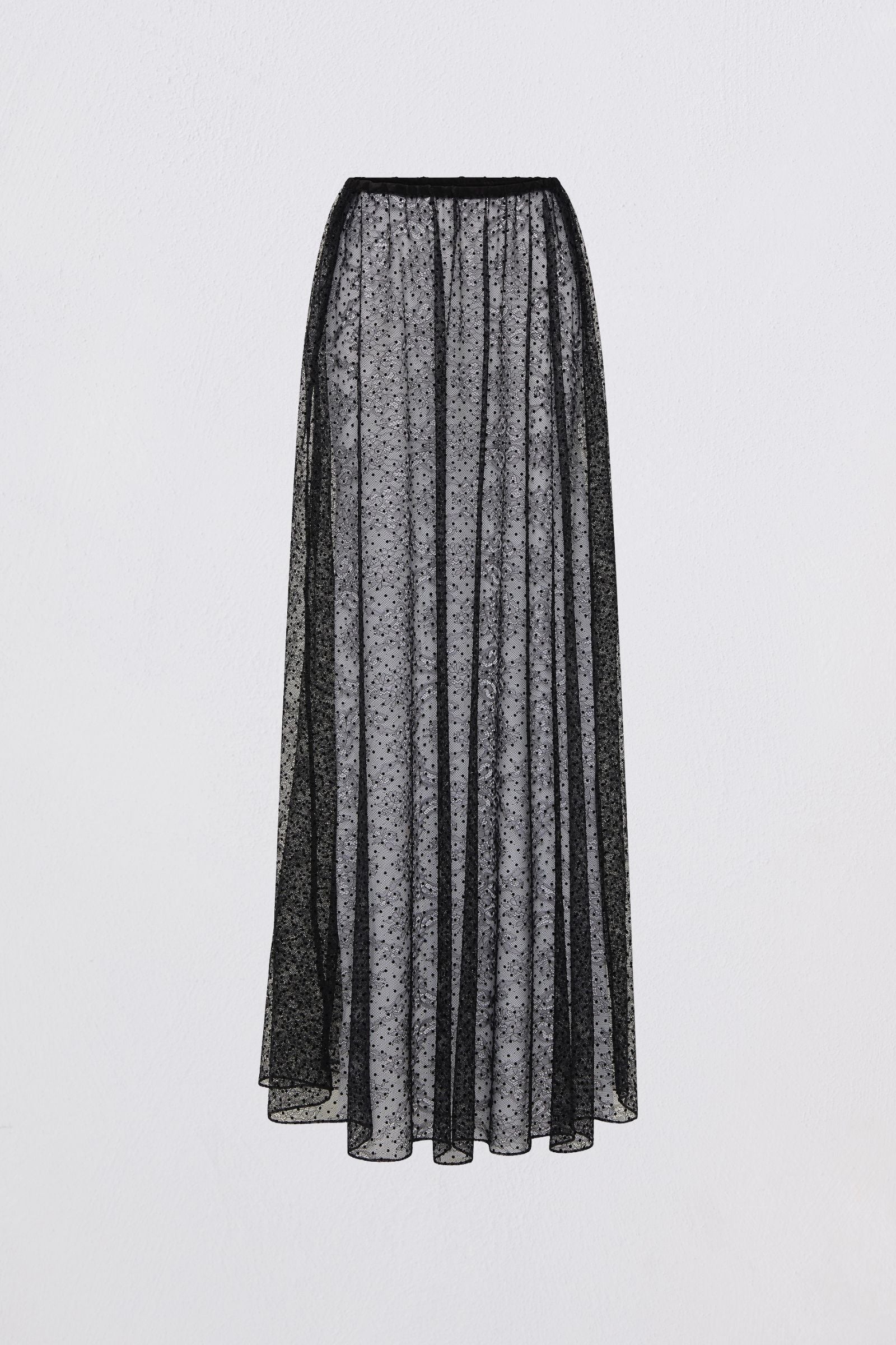 Long black skirt with a subtle pattern on a light gray background