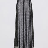 Long black skirt with a subtle pattern on a light gray background