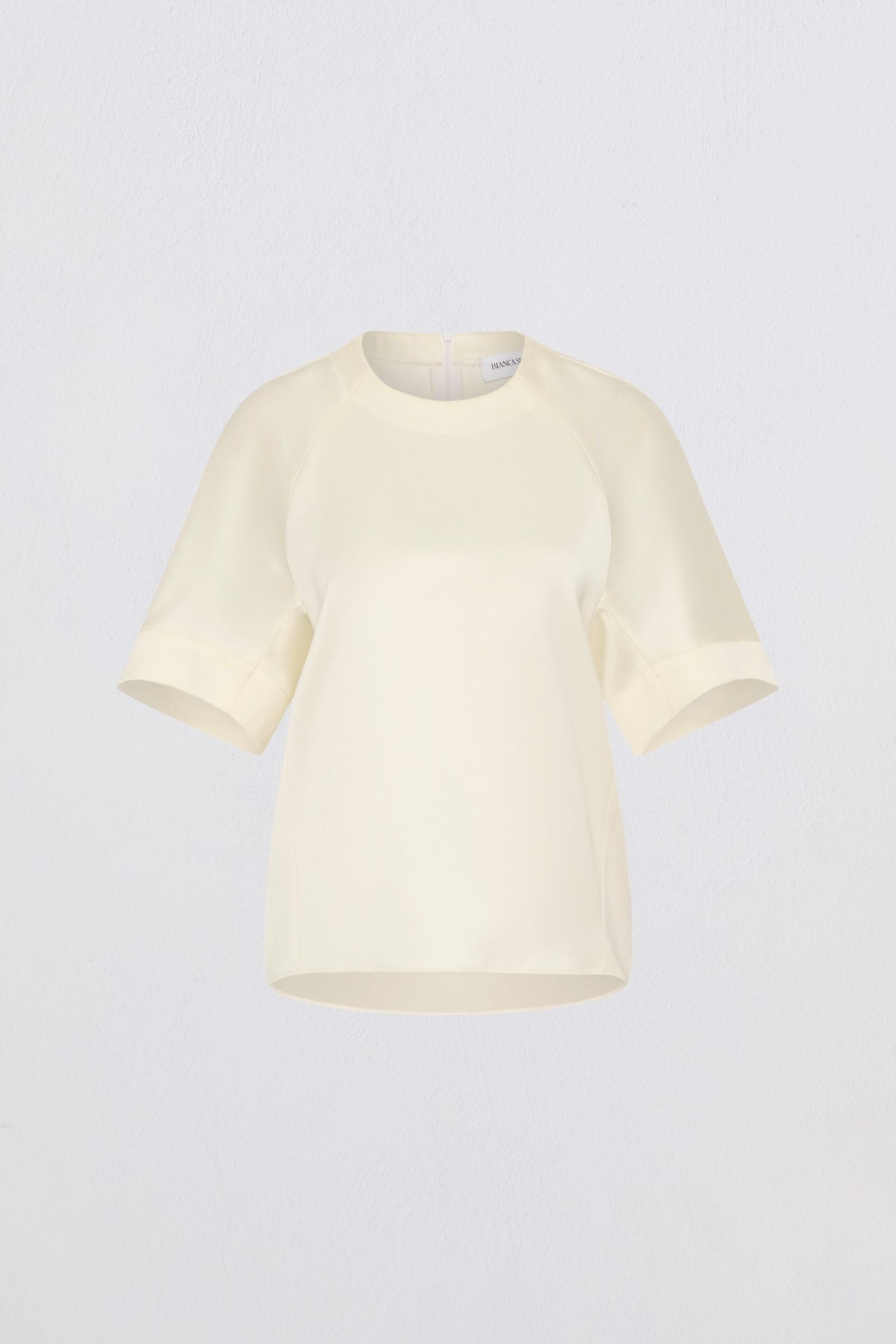 Cream t-shirt on a light gray background