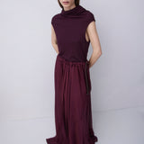 Plum jersey top with a relaxed fit, wide adjustable funnel neck and softly draped silhouette, photographed against a plain white studio background.