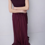 Plum jersey top with a relaxed fit, wide adjustable funnel neck and softly draped silhouette, photographed against a plain white studio background.