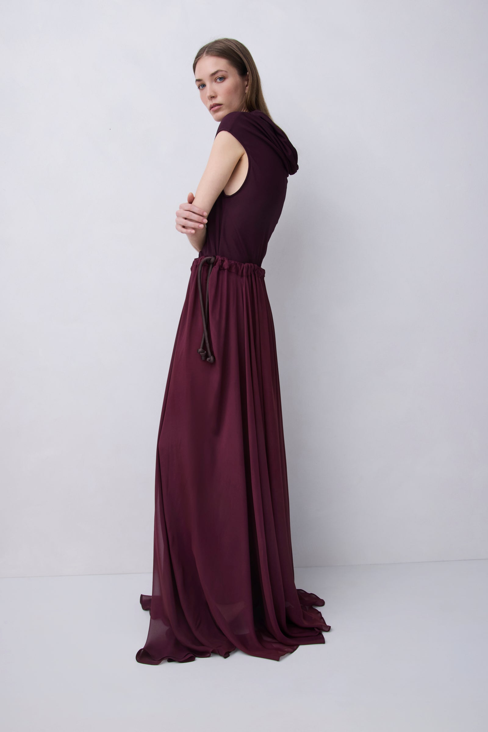 Plum jersey top with a relaxed fit, wide adjustable funnel neck and softly draped silhouette, photographed against a plain white studio background.