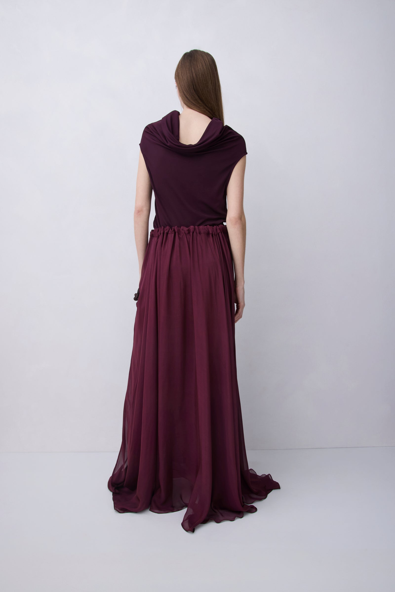 Plum jersey top with a relaxed fit, wide adjustable funnel neck and softly draped silhouette, photographed against a plain white studio background.