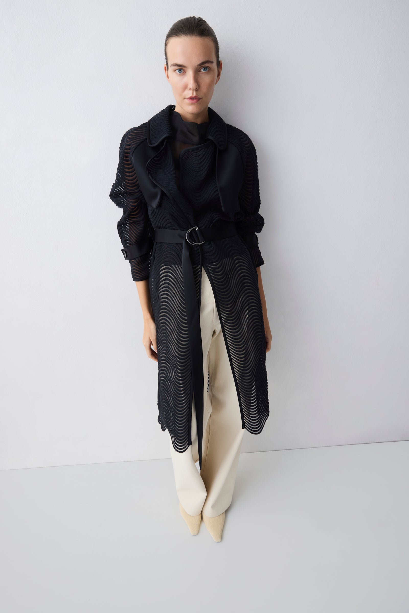 Woman wearing a black outfit with a white background