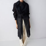 Woman wearing a black outfit with a white background