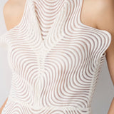 White sleeveless top with wavy pattern on a neutral background