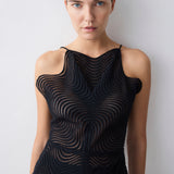 Black sleeveless dress with wavy pattern on a plain background