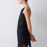 Black sleeveless dress with wavy pattern on a plain background
