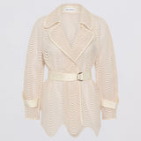 Beige textured coat with a belt on a light gray background