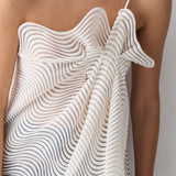 White dress with wavy pattern on a plain background