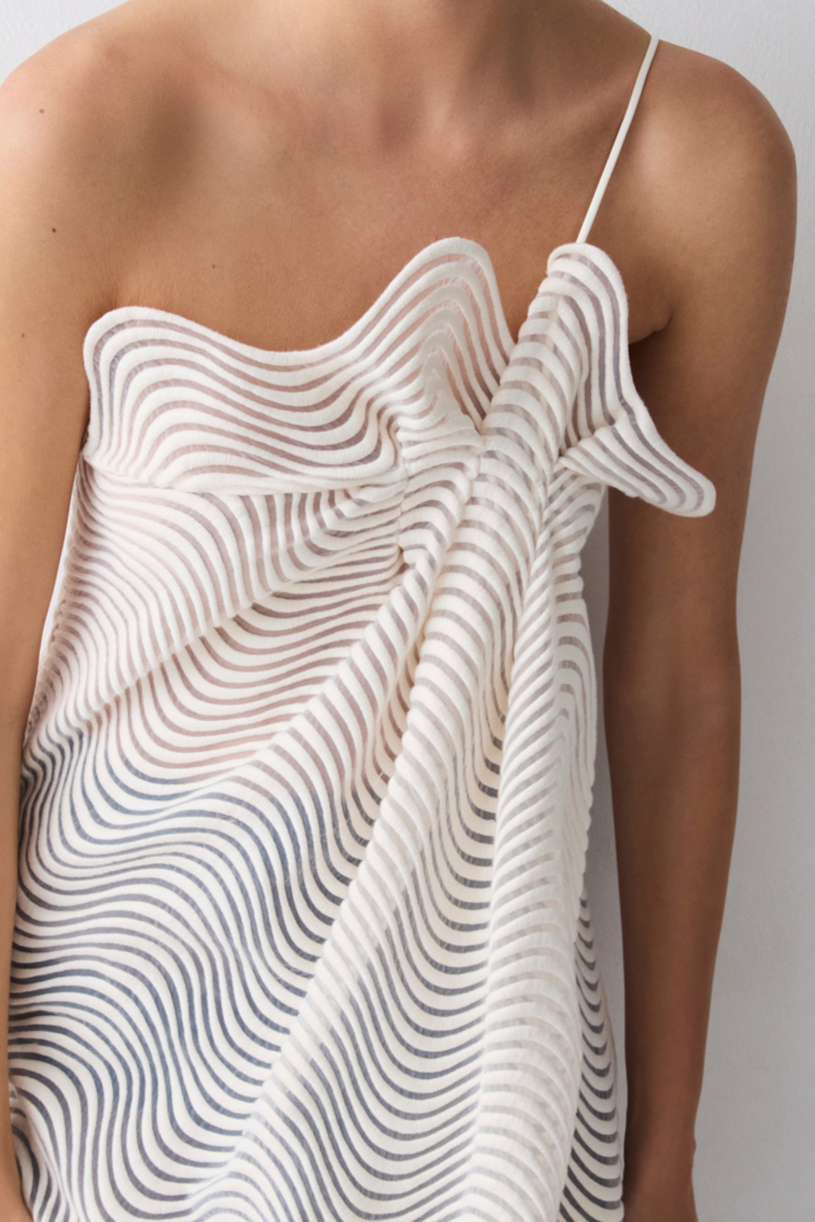 White dress with wavy pattern on a plain background