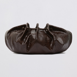 A dark brown textured leather clutch bag with a gathered, ruched top design, photographed against a neutral light gray background.