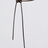 A dark brown textured leather belt with a simple circular loop and a small knot at the front, displayed against a solid light gray background.