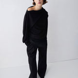 Person wearing a black outfit on a white background