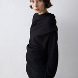 Person wearing a black outfit against a white background
